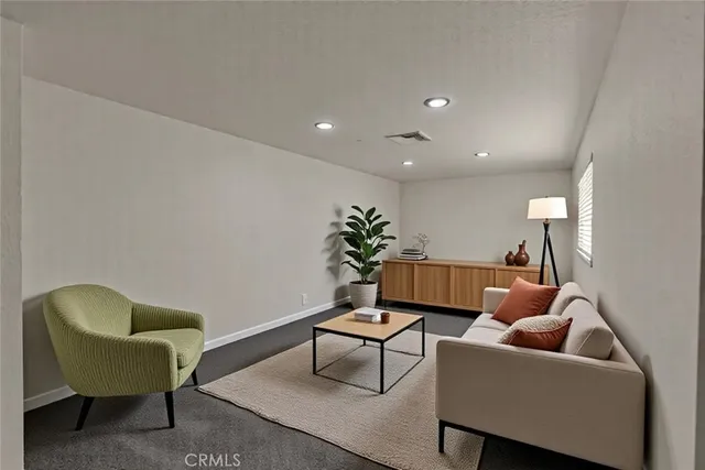 a living room with furniture and a potted plant
