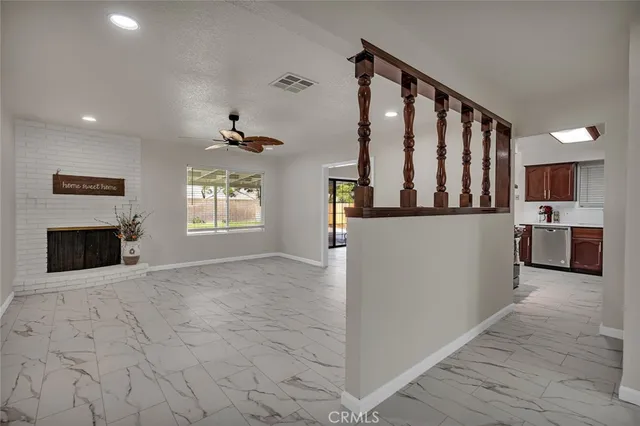 a view of a living room with furniture and a fireplace