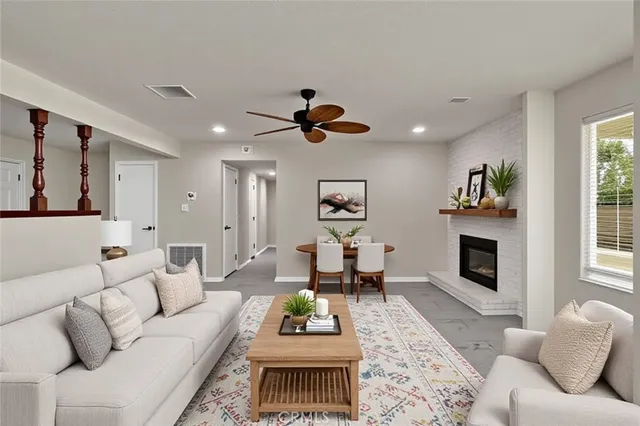 a living room with furniture a fireplace and a flat screen tv