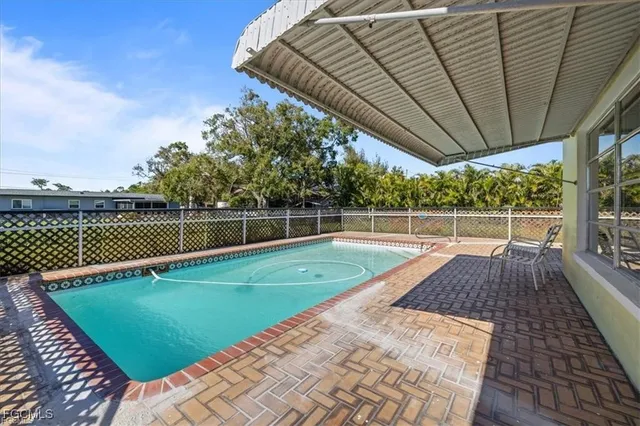 a view of a backyard with sitting area