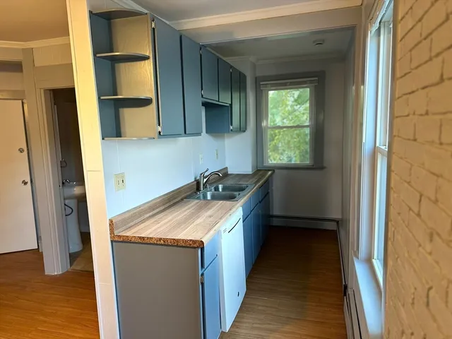 a kitchen with a stove a sink and a refrigerator