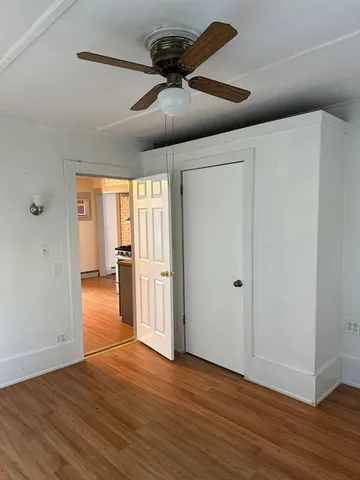 a view of an empty room and wooden floor