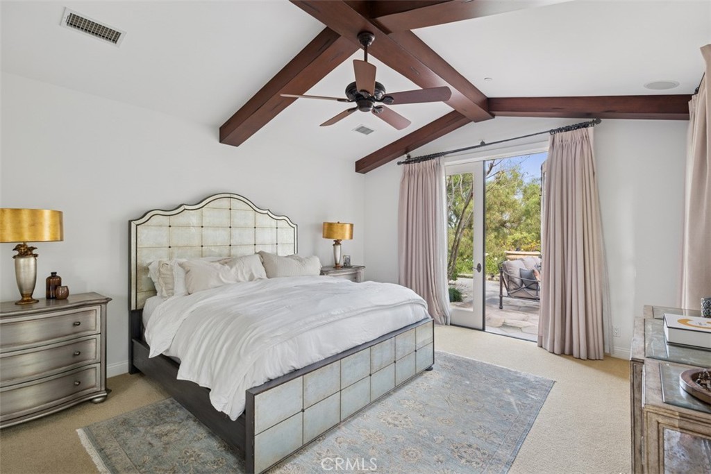 25 Wild Hawk Irvine, CA 92603 - Photo 23 of 36 a bedroom with a large bed and a chandelier