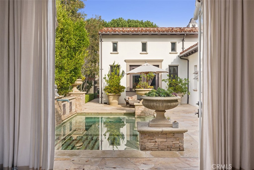 25 Wild Hawk Irvine, CA 92603 - Photo 25 of 36 a view of a patio with table and chairs and potted plants