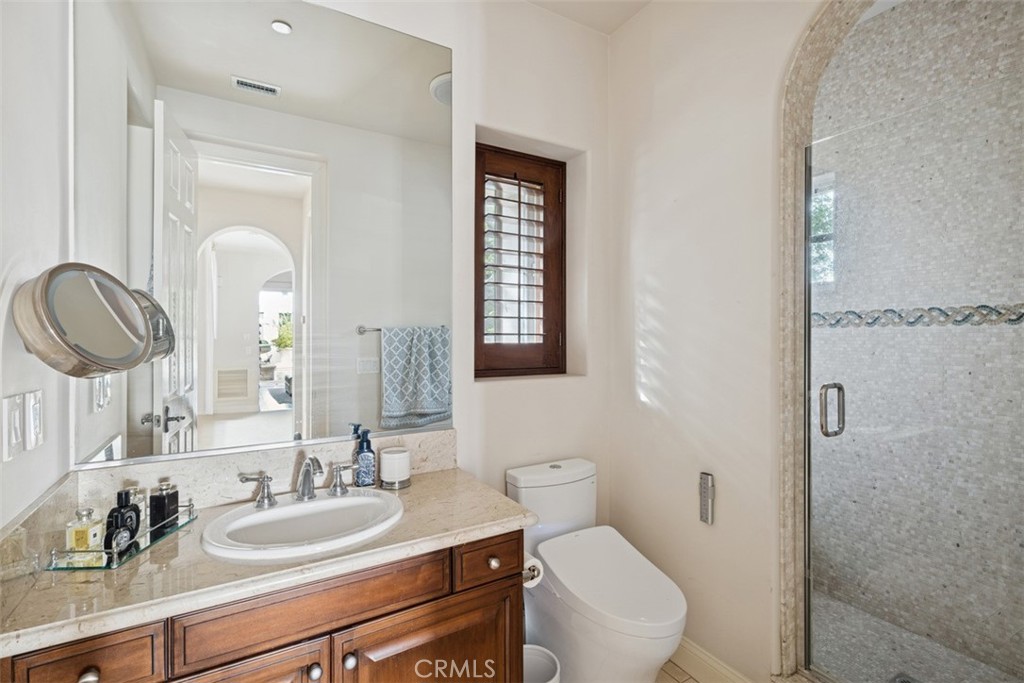 25 Wild Hawk Irvine, CA 92603 - Photo 28 of 36 a bathroom with a toilet a sink and mirror