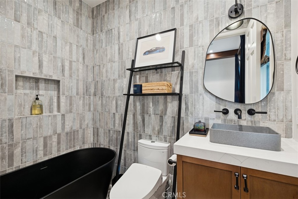 25 Wild Hawk Irvine, CA 92603 - Photo 30 of 36 a bathroom with a sink a toilet and mirror