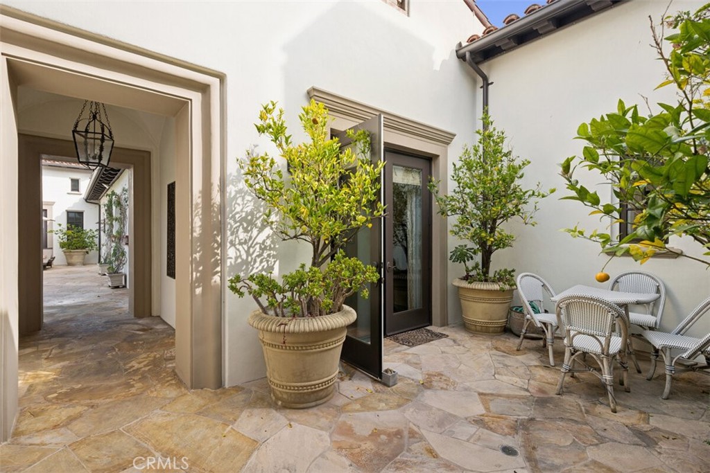 25 Wild Hawk Irvine, CA 92603 - Photo 5 of 36 a view of a entryway of the house with potted plants