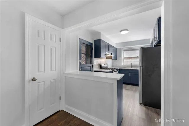 a kitchen with a sink a stove and cabinets
