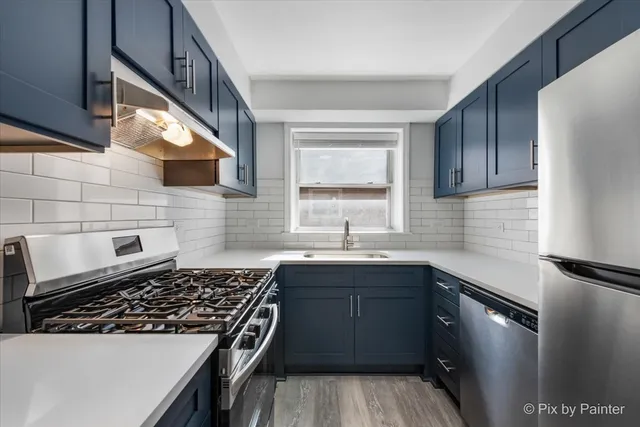 a kitchen with appliances and a refrigerator