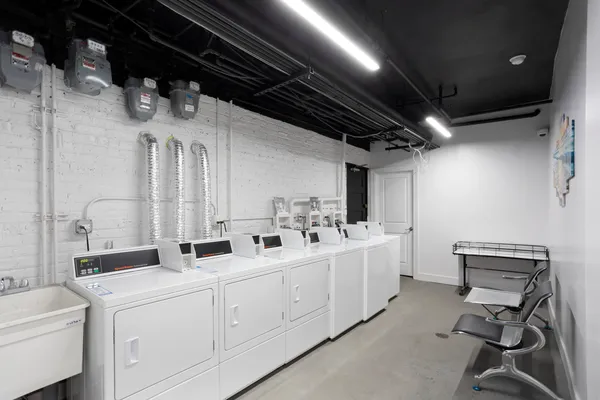a utility room with multiple dryer and washer