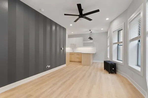 a view of a kitchen with a sink and a refrigerator