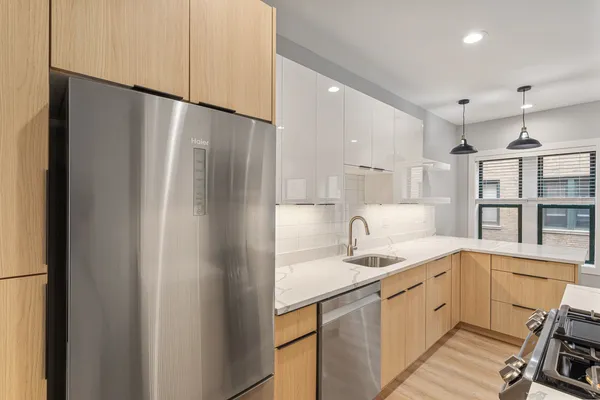 a kitchen with a sink stainless steel appliances and cabinets