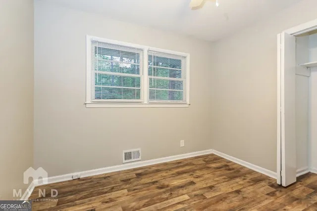 a view of a room with wooden floor and window