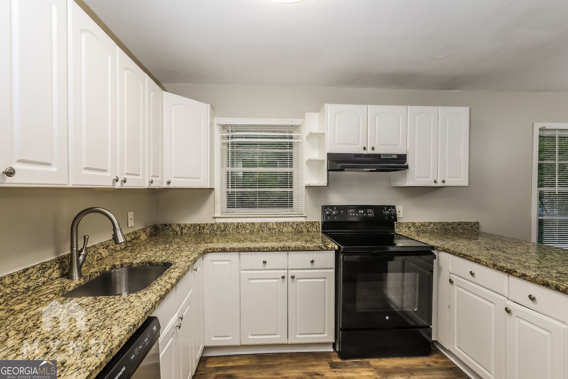 2644 Butner Road Atlanta, GA 30331 - Photo 4 of 21 a kitchen with granite countertop a sink a stove and cabinets
