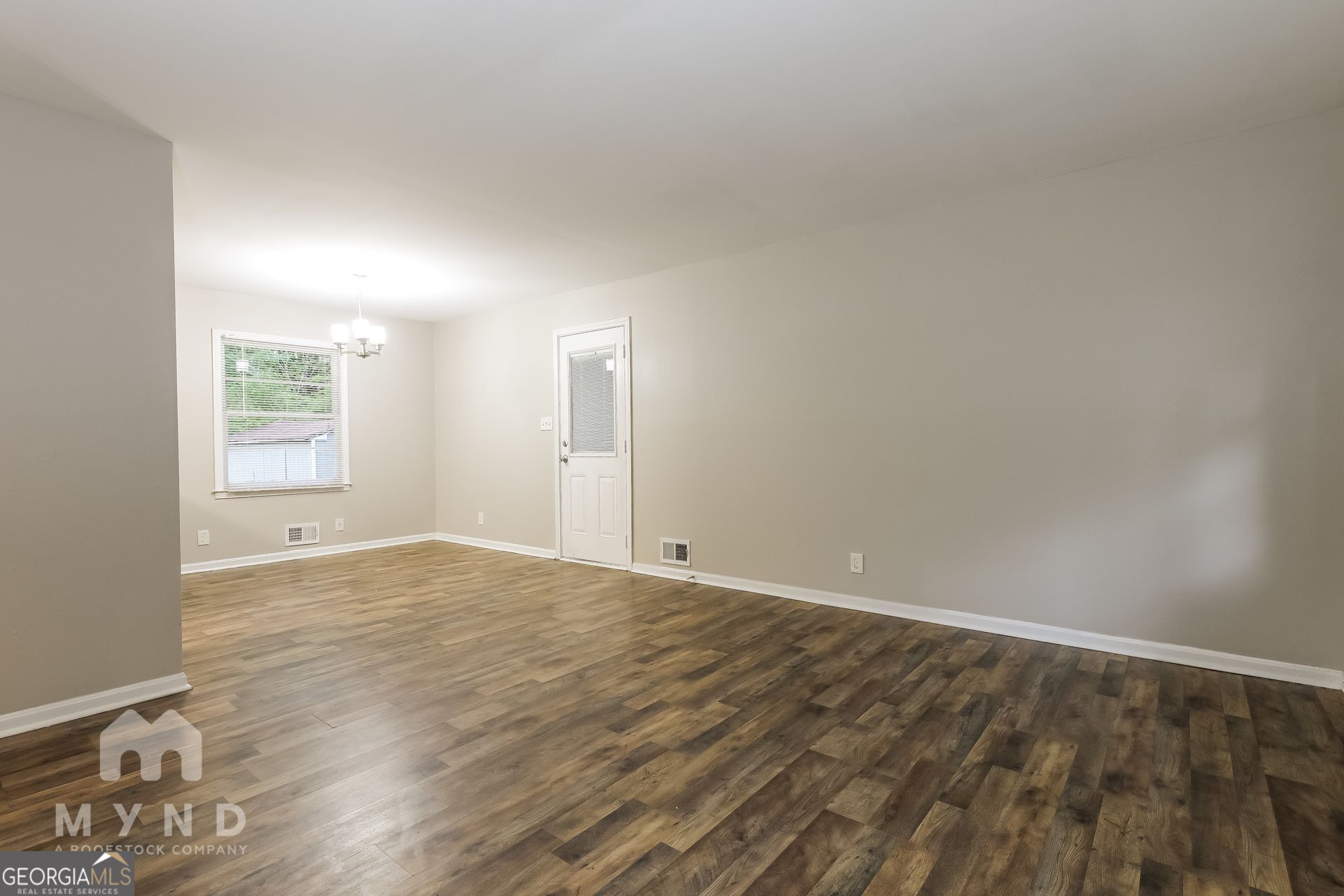 2644 Butner Road Atlanta, GA 30331 - Photo 9 of 21 an empty room with wooden floor and windows