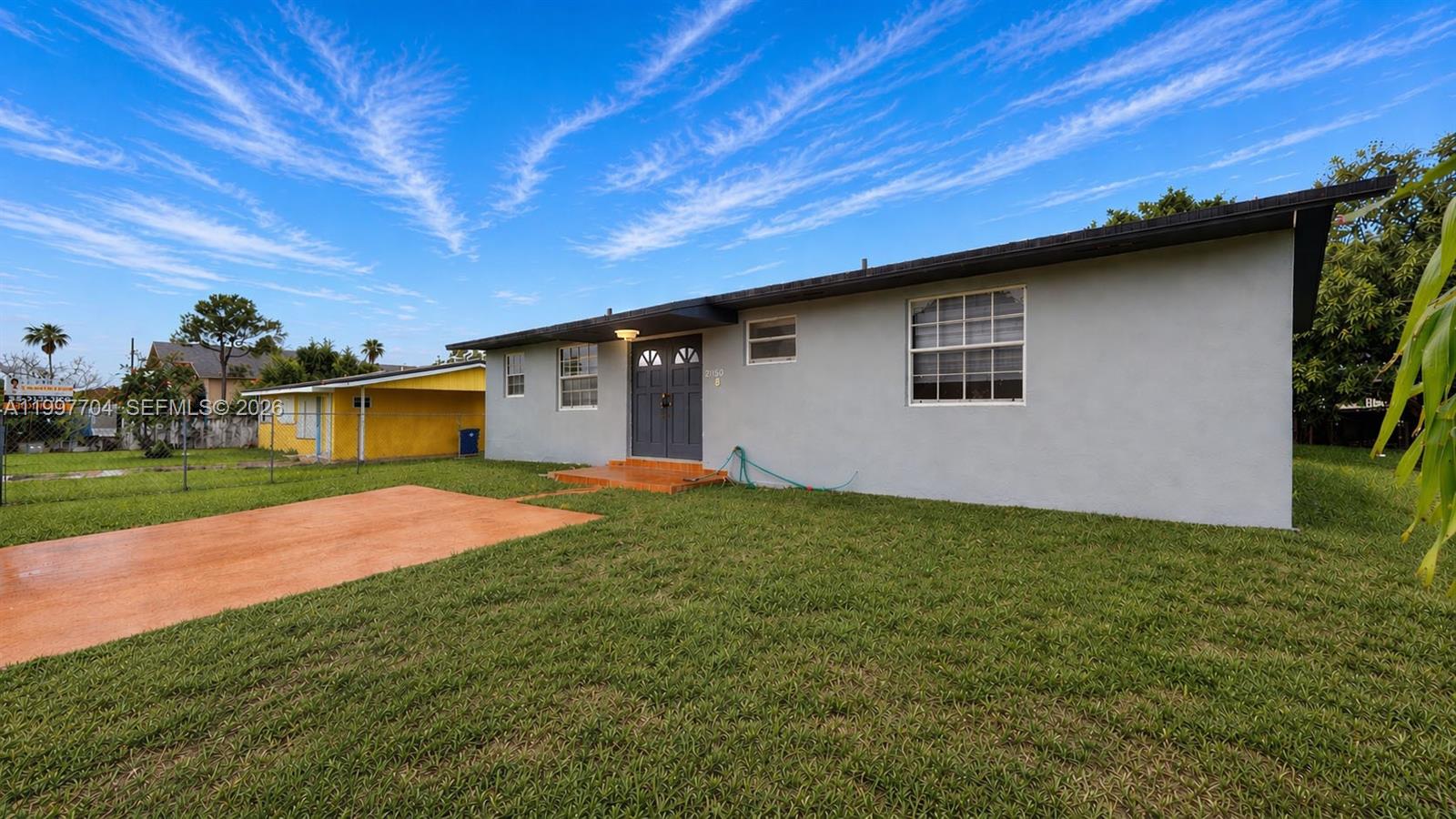 21450 Southwest 109th Court Miami, FL 33170 - Photo 1 of 43 a backyard of a house with large trees