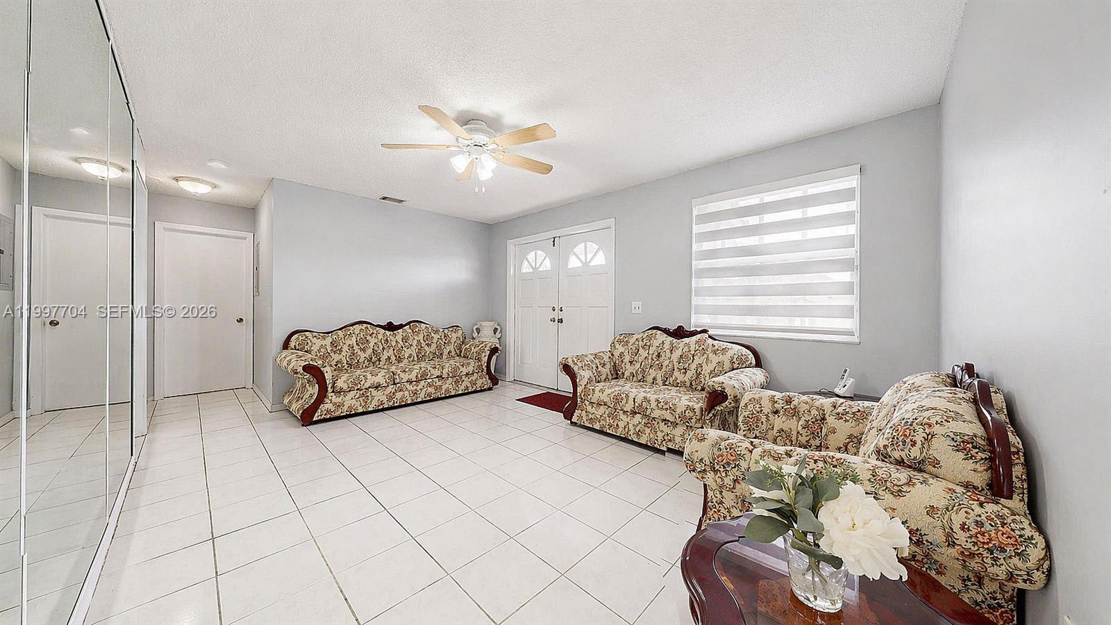 21450 Southwest 109th Court Miami, FL 33170 - Photo 18 of 43 a spacious bedroom with a bed and a chandelier