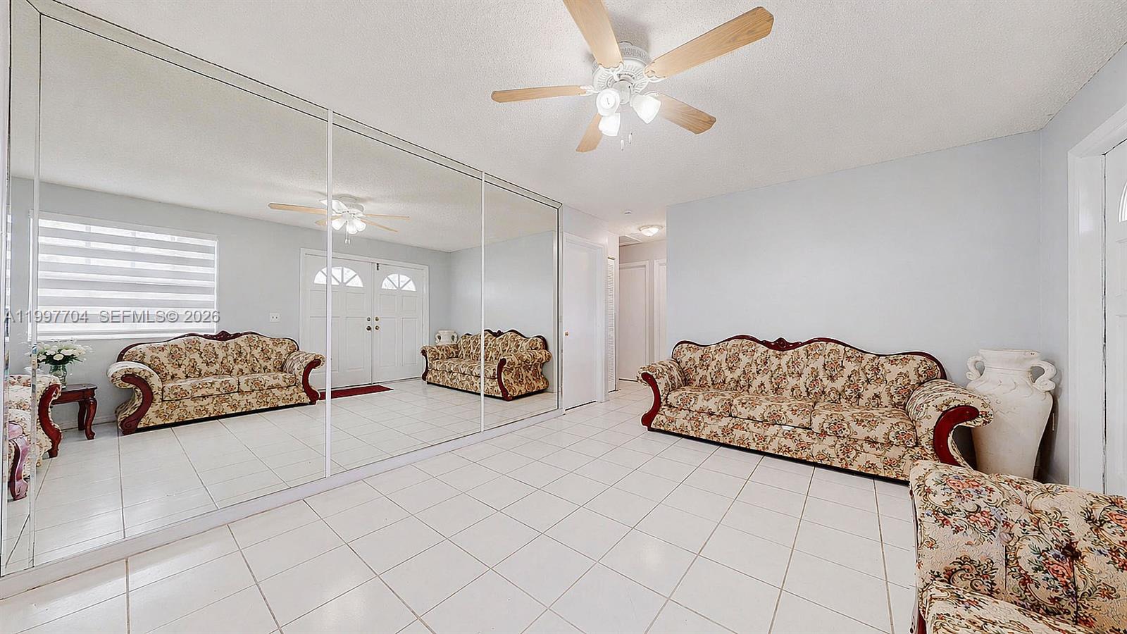 21450 Southwest 109th Court Miami, FL 33170 - Photo 19 of 43 a spacious bedroom with a bed and a couch