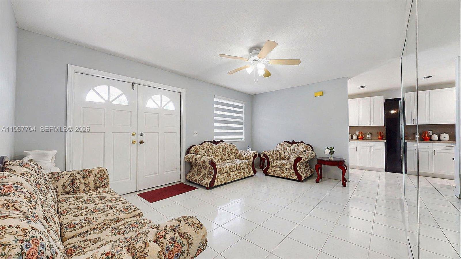 21450 Southwest 109th Court Miami, FL 33170 - Photo 20 of 43 a spacious bedroom with a bed and a chandelier