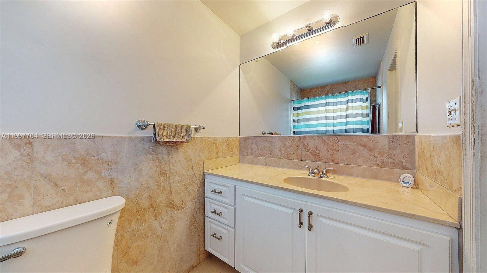 21450 Southwest 109th Court Miami, FL 33170 - Photo 22 of 43 a bathroom with a sink and a mirror