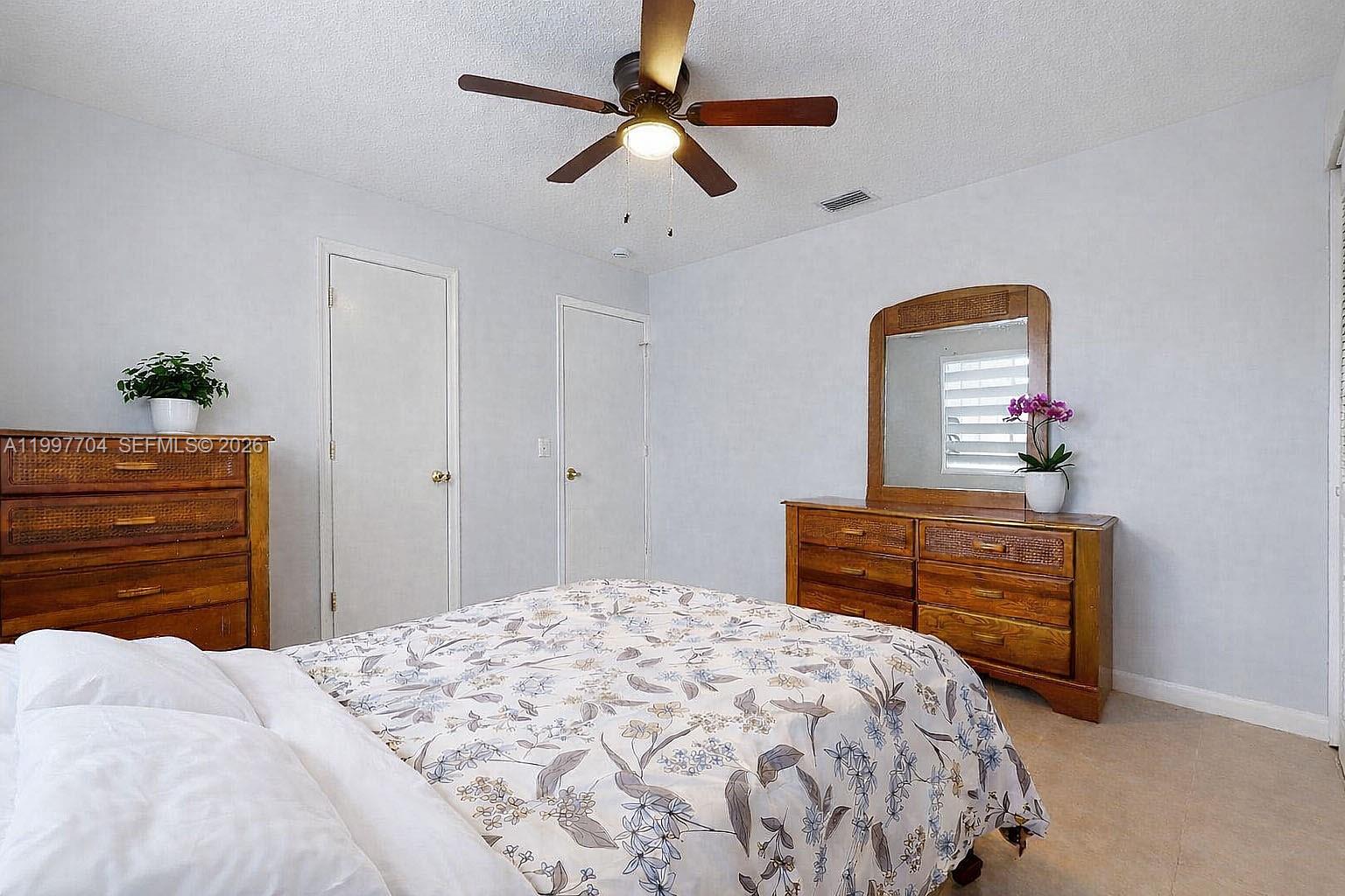 21450 Southwest 109th Court Miami, FL 33170 - Photo 24 of 43 a bedroom with a bed and a dresser