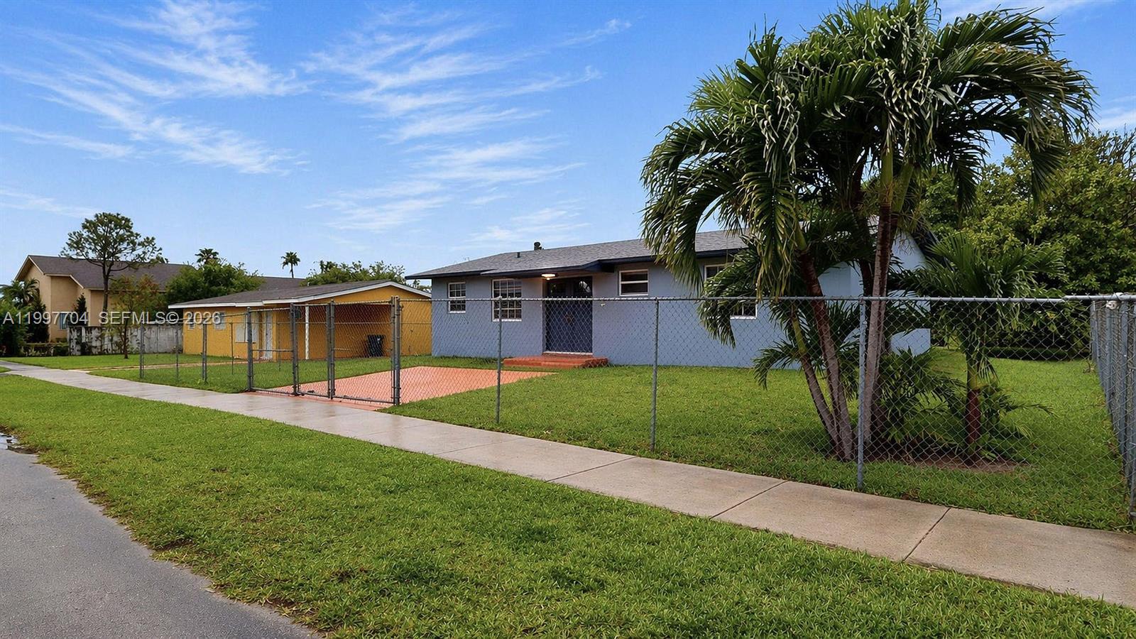 21450 Southwest 109th Court Miami, FL 33170 - Photo 31 of 43 a front view of a house with garden