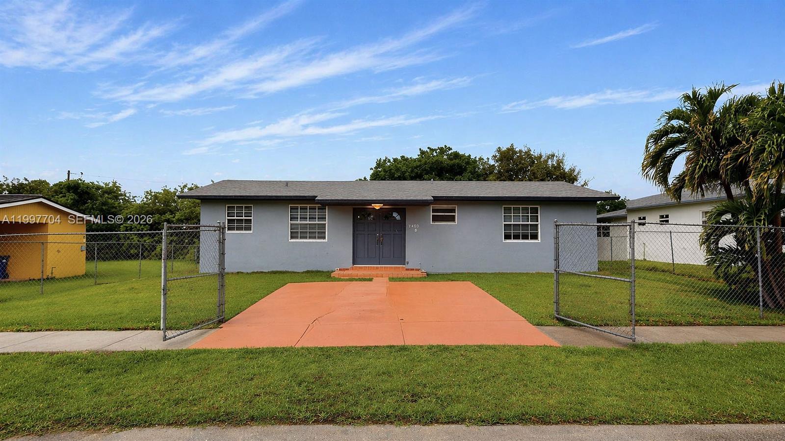 21450 Southwest 109th Court Miami, FL 33170 - Photo 33 of 43 a front view of a house with a yard and garage