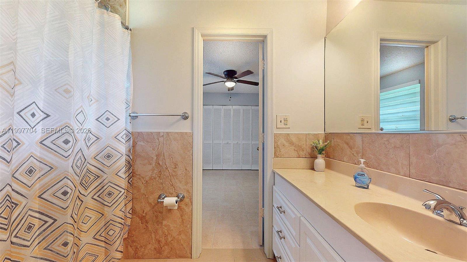 21450 Southwest 109th Court Miami, FL 33170 - Photo 39 of 43 a bathroom with a granite countertop shower sink and mirror