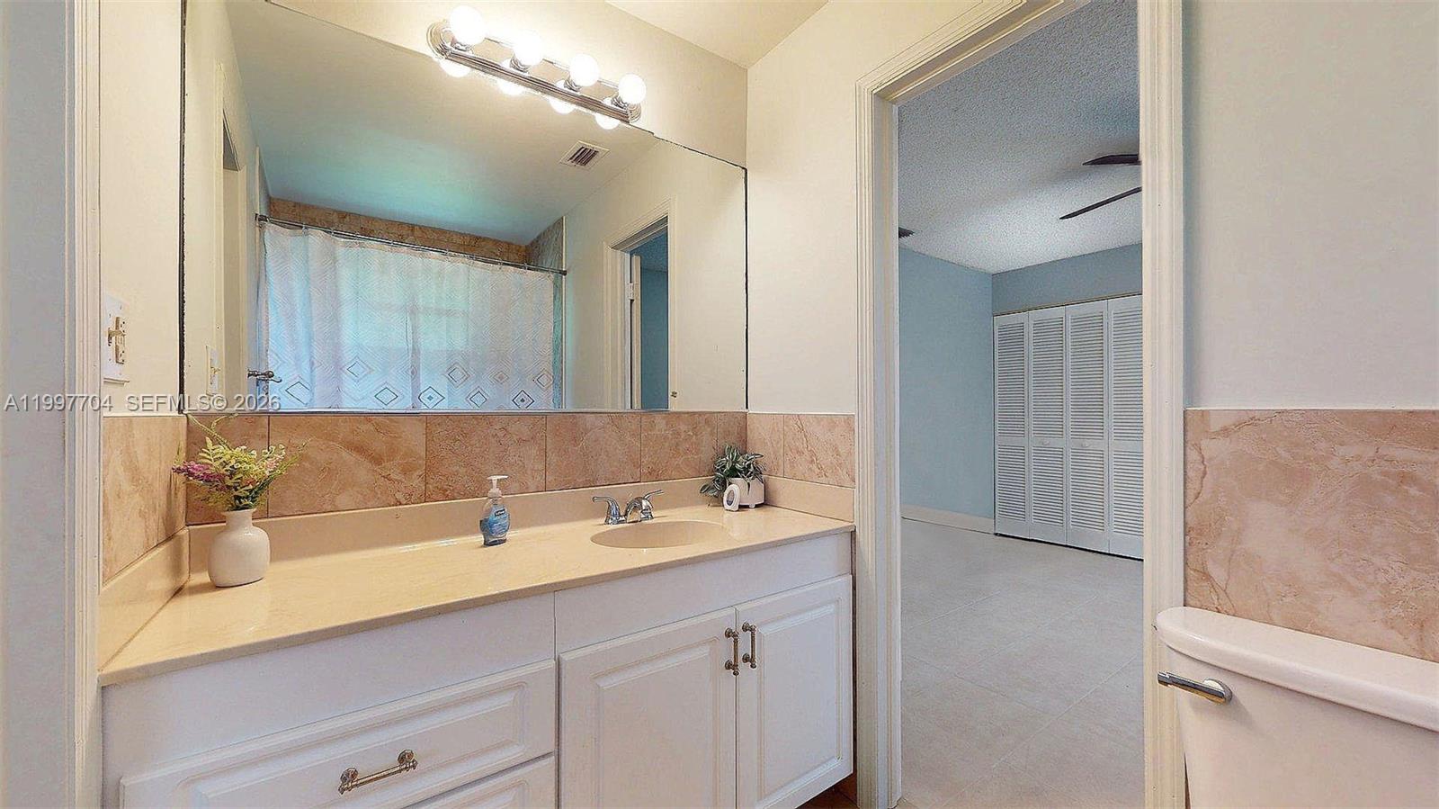 21450 Southwest 109th Court Miami, FL 33170 - Photo 40 of 43 a bathroom with a sink and a mirror