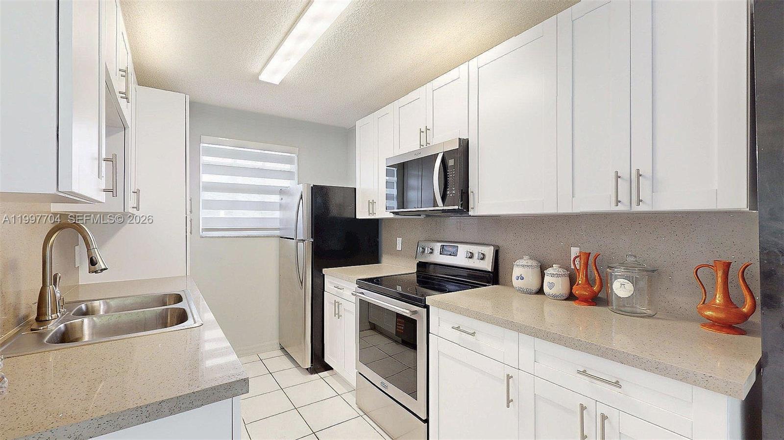 21450 Southwest 109th Court Miami, FL 33170 - Photo 43 of 43 a kitchen with stainless steel appliances granite countertop a sink a stove a refrigerator and cabinets
