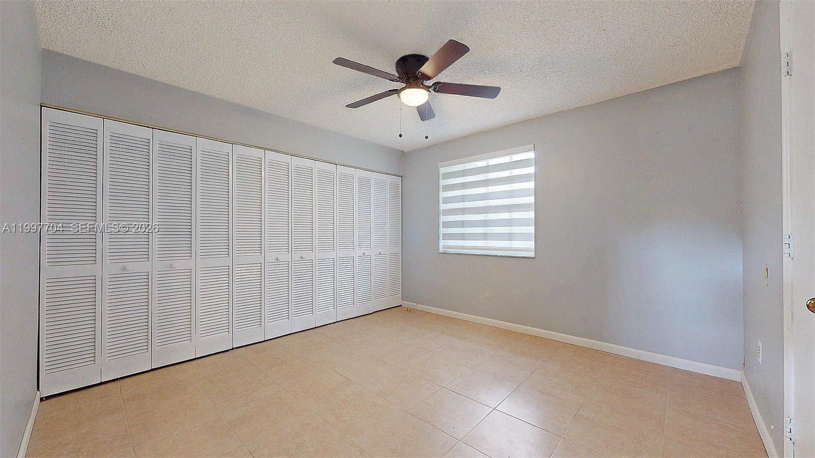 21450 Southwest 109th Court Miami, FL 33170 - Photo 7 of 43 a view of an empty room with a window