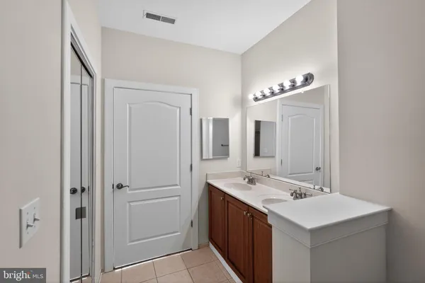 a bathroom with a sink a mirror and a shower