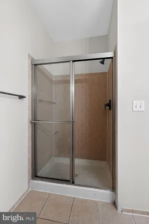 a bathroom with a glass shower door