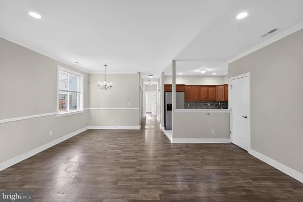 a view of a big room with wooden floor and windows