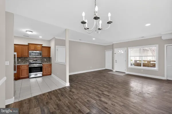 a view of kitchen with sink microwave and refrigerator