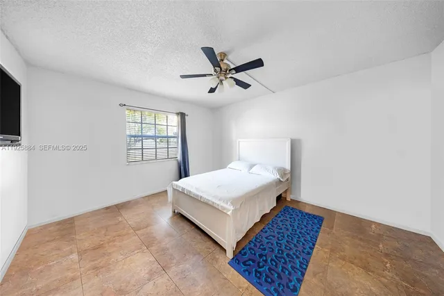 a living room with a bed furniture and a window