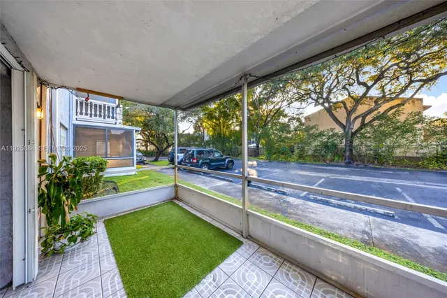 a view of porch with a bench next to a yard