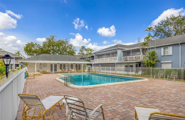 a view of a house with backyard and sitting area