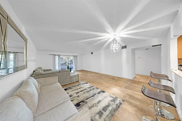 a bedroom with a large bed couch and a window