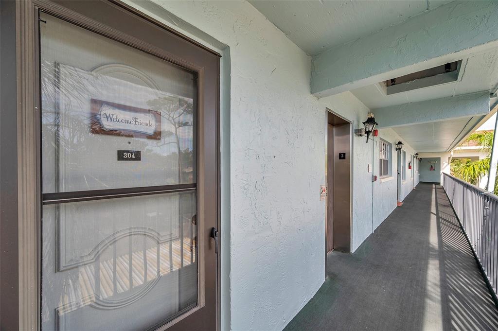 1430 Heather Ridge Boulevard, Unit 304 Dunedin, FL 34698 - Photo 1 of 36 a view of a hallway with a hallway