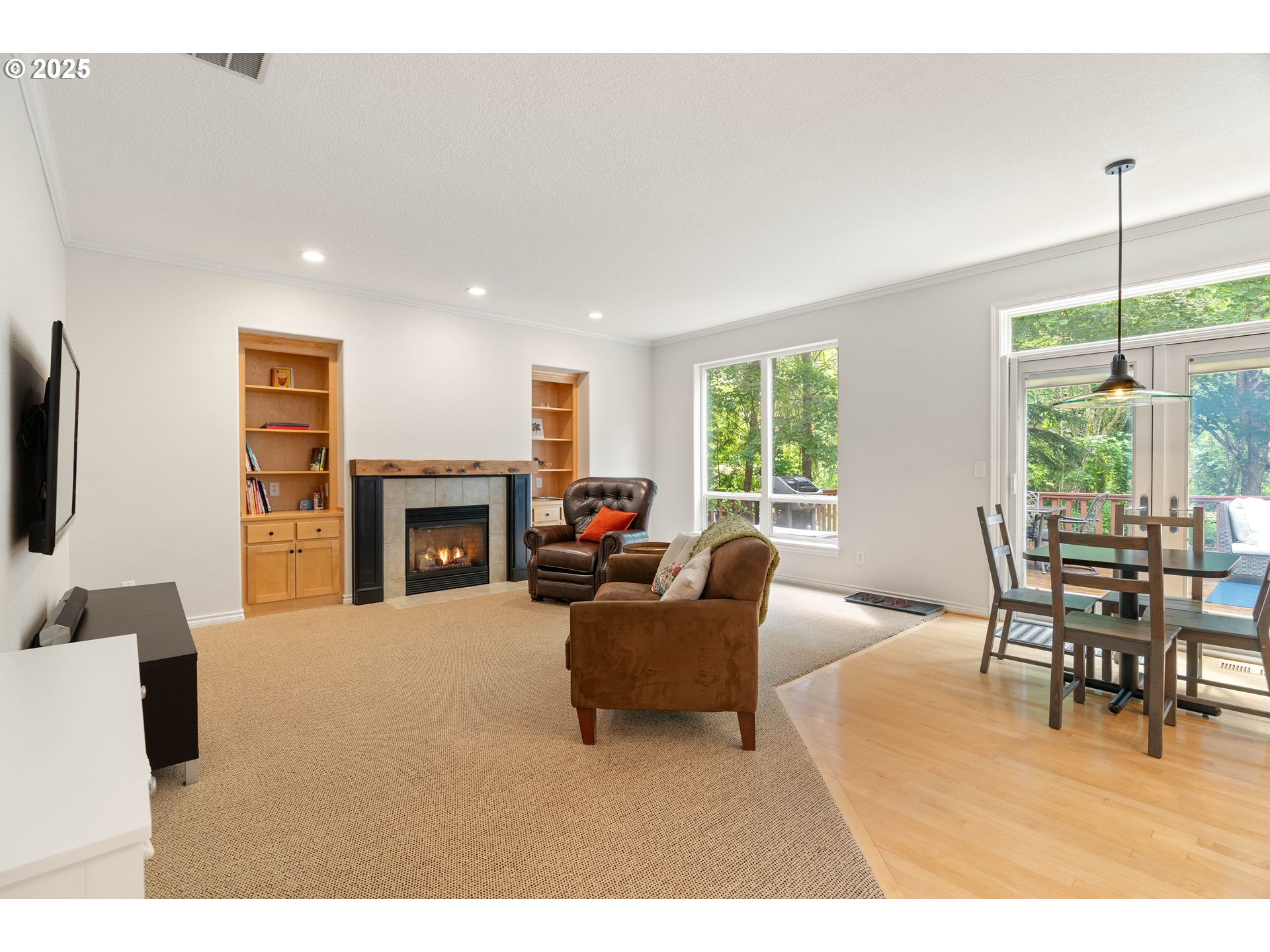 4014 Southwest 96th Avenue Portland, OR 97225 - Photo 12 of 48 a living room with furniture a fireplace and a dining table