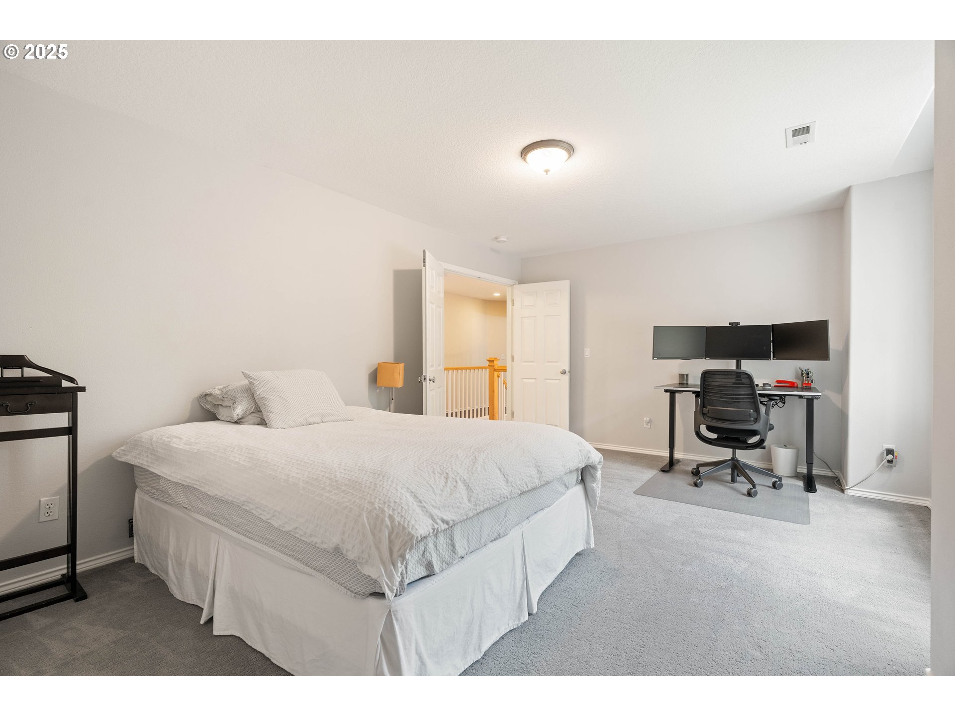 4014 Southwest 96th Avenue Portland, OR 97225 - Photo 23 of 48 a bedroom with a bed a table and chair
