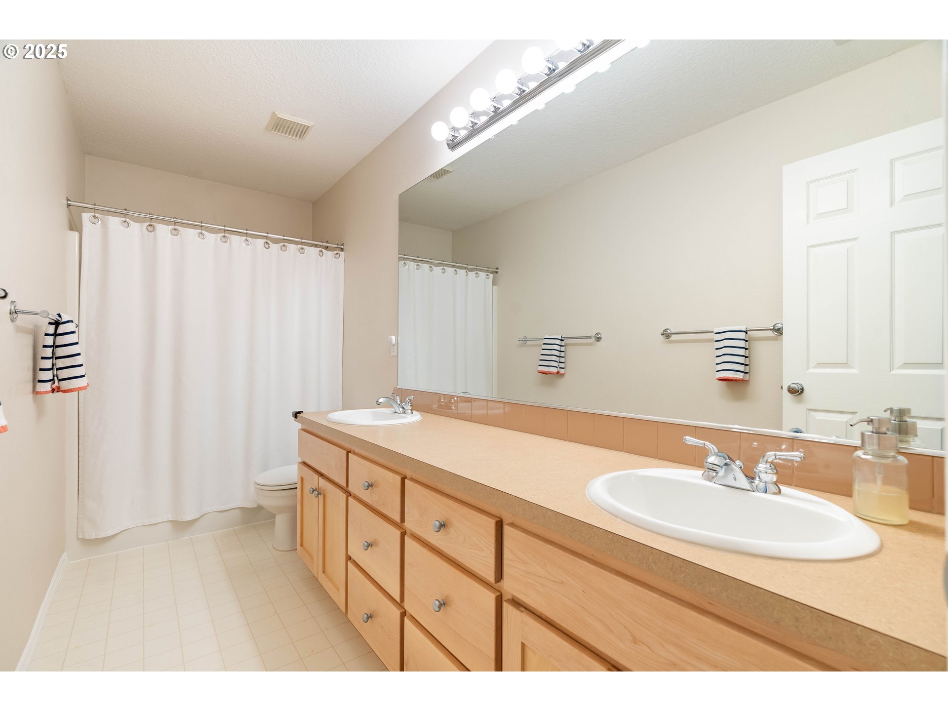 4014 Southwest 96th Avenue Portland, OR 97225 - Photo 24 of 48 a bathroom with a sink double vanity and a mirror