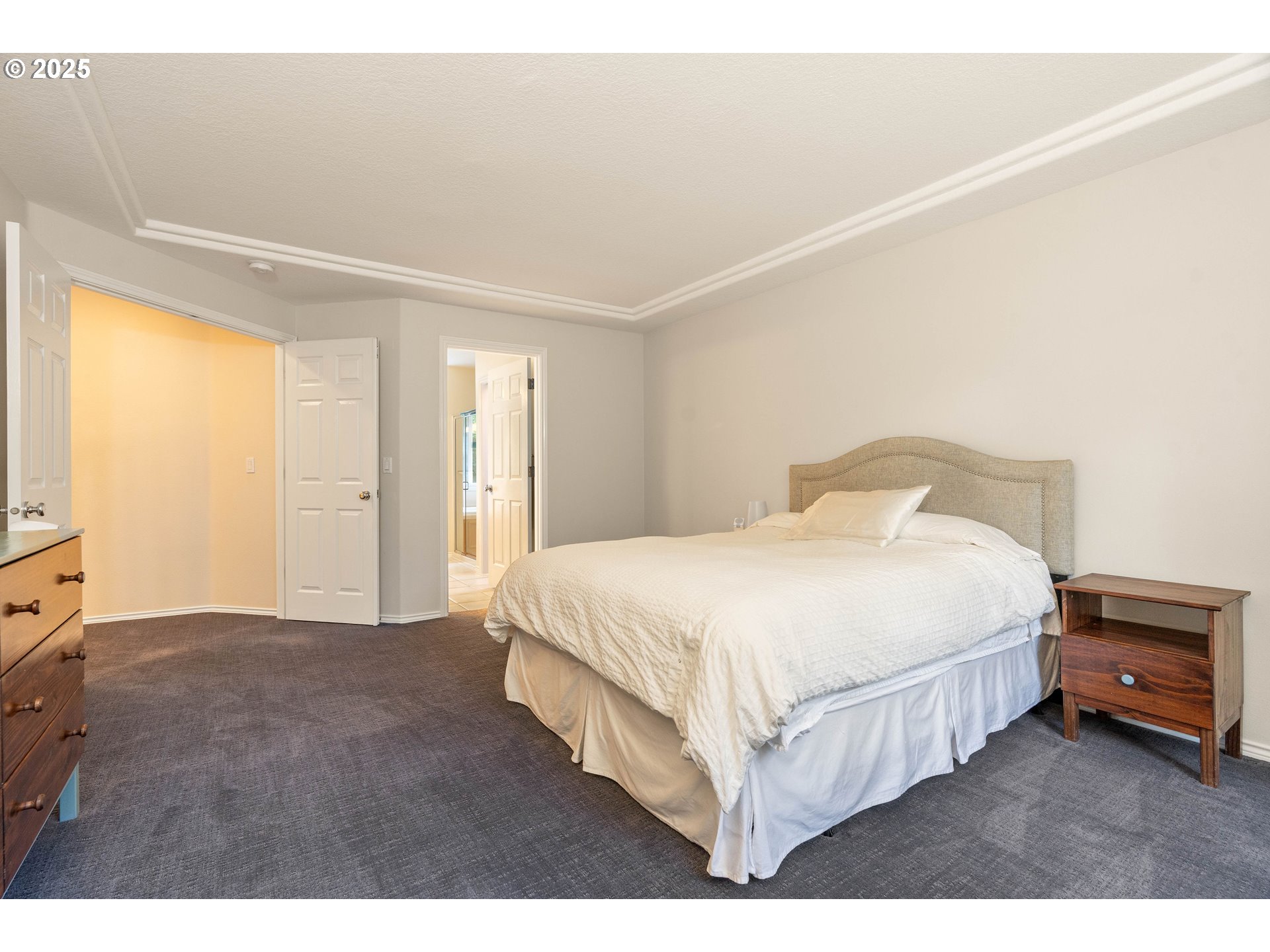 4014 Southwest 96th Avenue Portland, OR 97225 - Photo 30 of 48 a bedroom with a bed and a flat tv screen on dresser