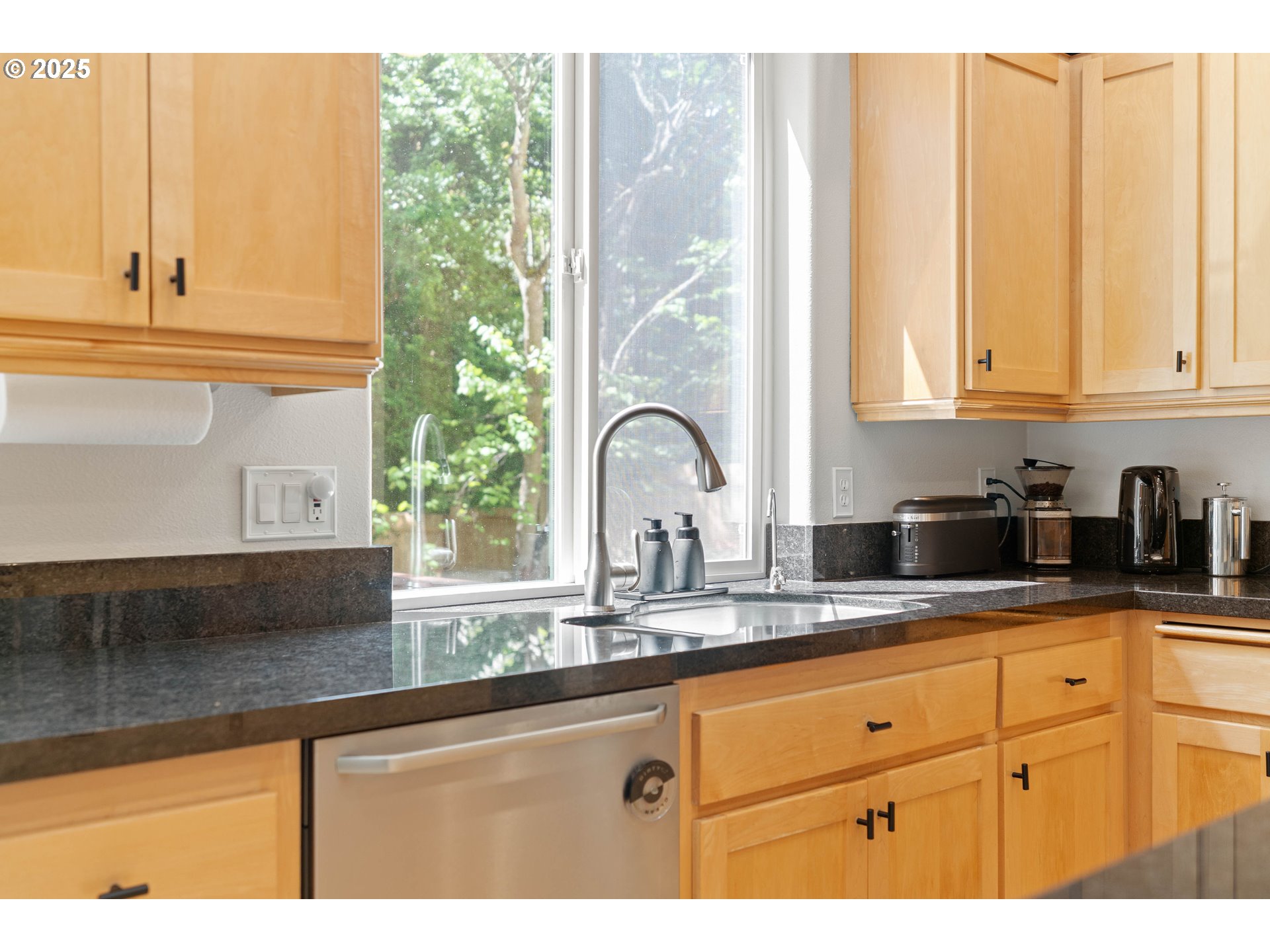 4014 Southwest 96th Avenue Portland, OR 97225 - Photo 4 of 48 a kitchen with granite countertop white cabinets and window