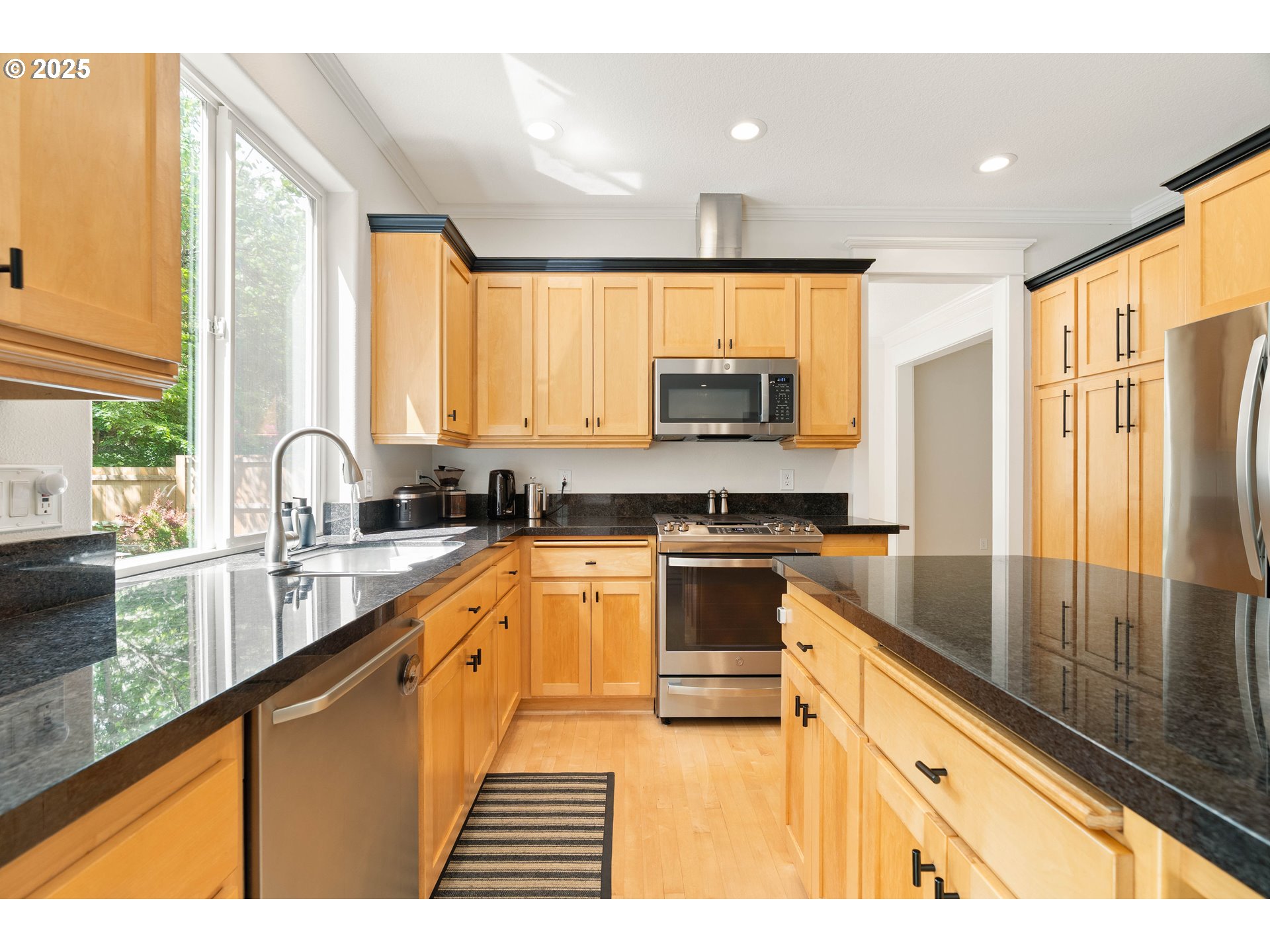4014 Southwest 96th Avenue Portland, OR 97225 - Photo 5 of 48 a kitchen with stainless steel appliances granite countertop a sink a stove and a refrigerator