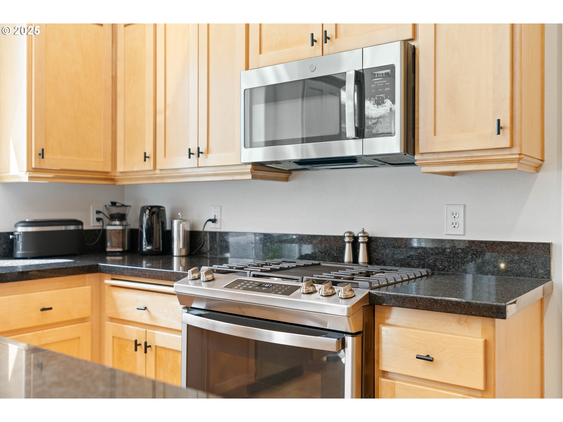 4014 Southwest 96th Avenue Portland, OR 97225 - Photo 6 of 48 a kitchen with stainless steel appliances granite countertop a sink and a stove