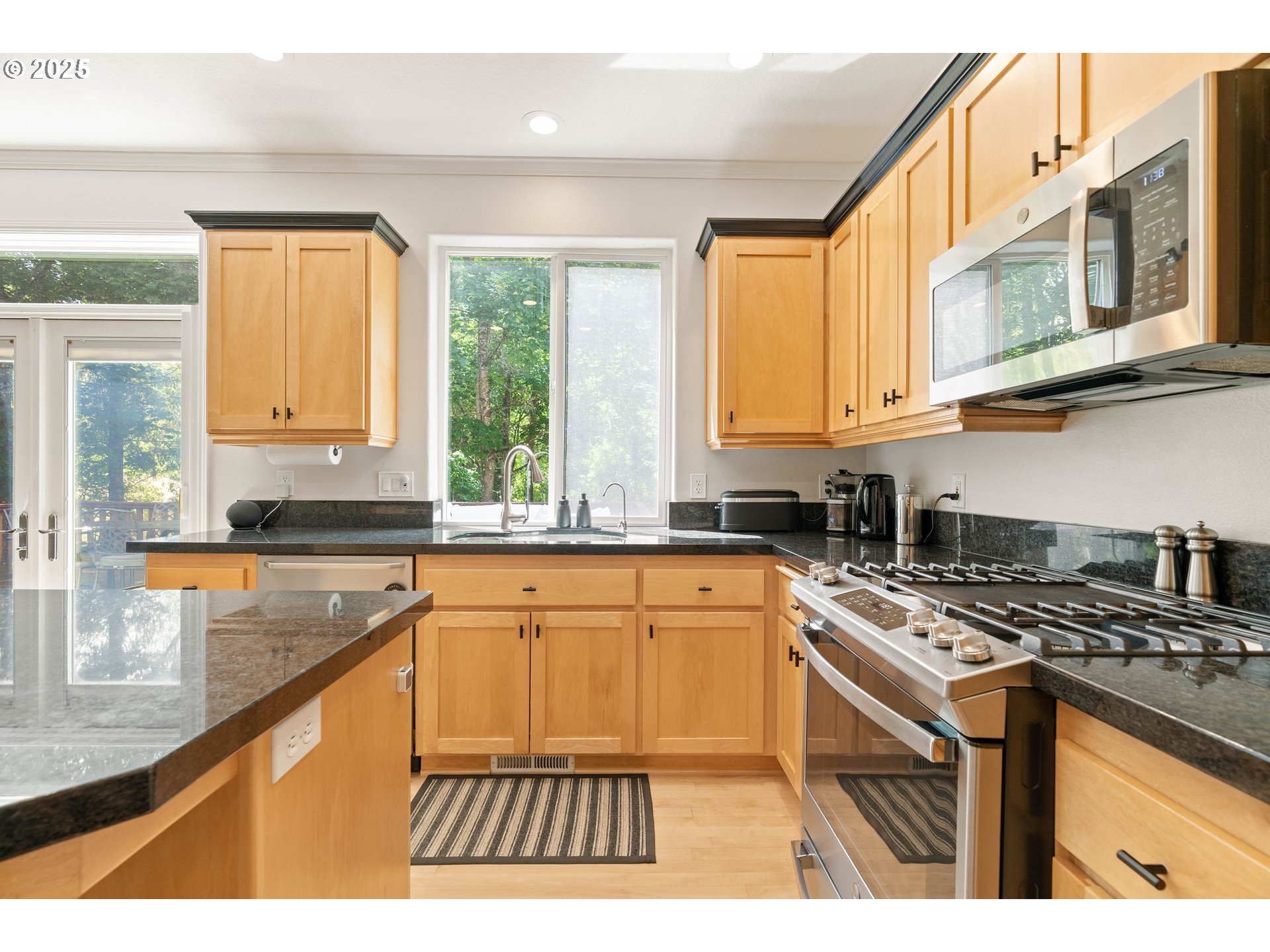4014 Southwest 96th Avenue Portland, OR 97225 - Photo 7 of 48 a kitchen with stainless steel appliances granite countertop a stove a sink and a microwave