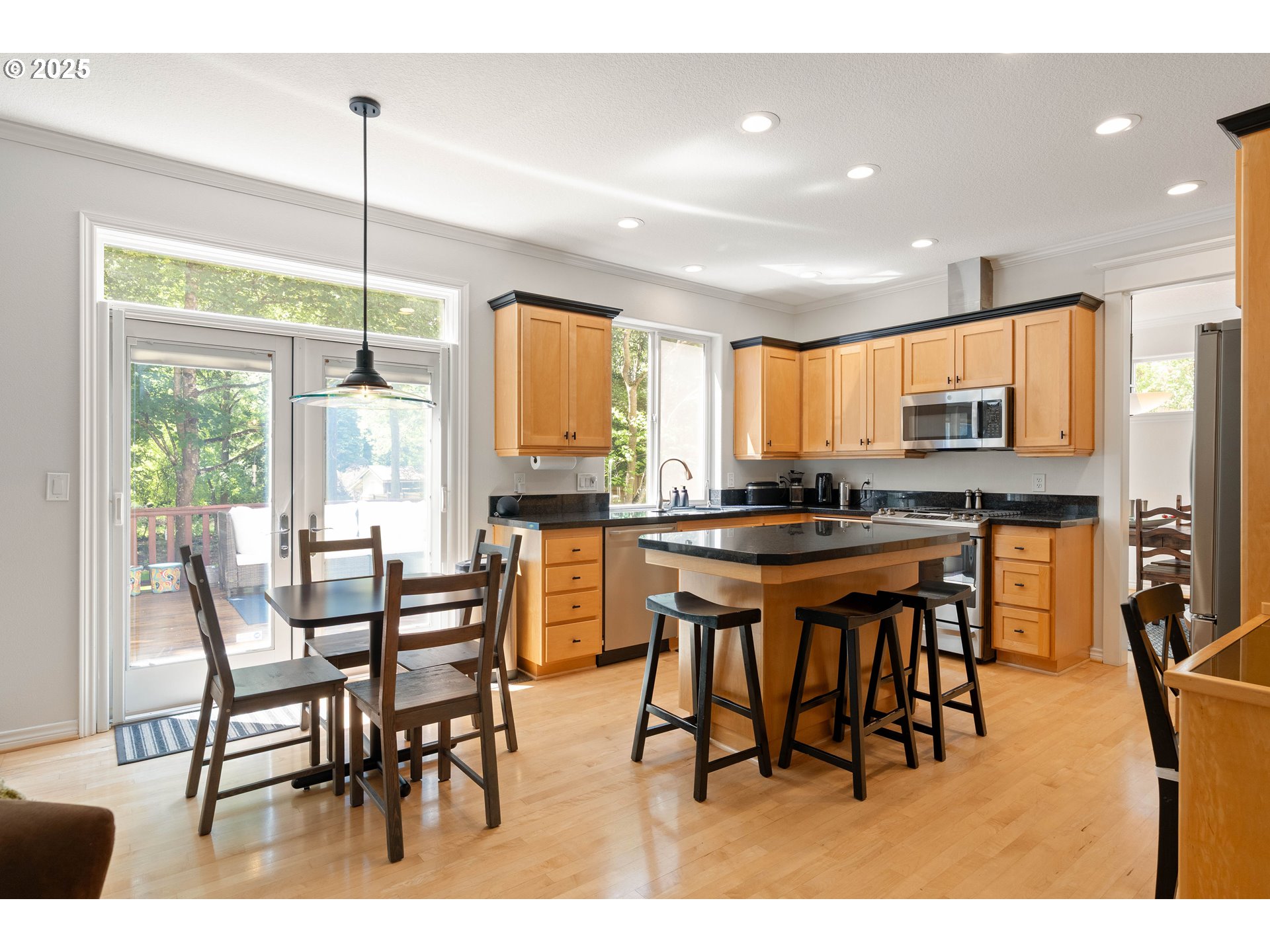 4014 Southwest 96th Avenue Portland, OR 97225 - Photo 10 of 48 a open kitchen with stainless steel appliances granite countertop a stove a sink a dining table and chairs