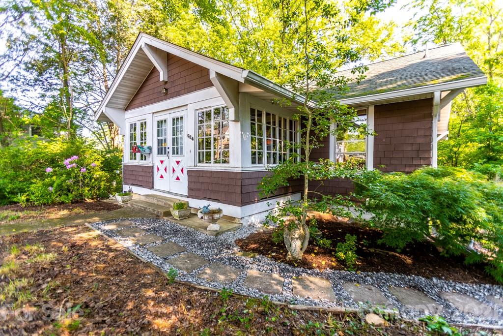 a view of a house with a yard and sitting area